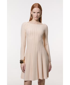 This Karen Millen knitted dress combines timeless elegance with contemporary design through its sophisticated pointelle stitch detailing. The fit and flare silhouette creates a naturally feminine shape that works wonderfully for daytime occasions. Style with statement earrings as shown for casual family gatherings, or pair with a structured crossbody bag and ballet flats for weekend brunches. For cooler days, layer with a cropped denim jacket and ankle boots for an effortlessly chic ensemble. The versatile boat neckline allows for various jewellery options; try a delicate pendant necklace to complement without overwhelming. This dress transitions seamlessly from office to evening drinks when accessorised thoughtfully, making it a wardrobe staple that offers countless styling possibilities throughout the seasons.  Elegant boat neckline frames the decolletage beautifully Distinctive pointelle stitch detailing creates visual interest throughout Flattering fit and flare silhouette accentuates the waistline Long sleeves offer versatility for transitional weather Soft knitted fabric provides comfort whilst maintaining structure