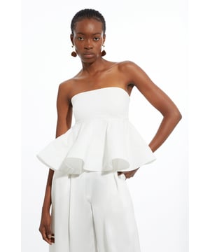 Feel elevated in our bandeau top, made with cotton fabric, with a fitted band that flares into a dramatically ruffled hemline. Style this piece with tailored trousers and pointed toe heels for an outfit that will turn heads from evening plans to party nights. Ruffle Hem Ponte And Cotton Jersey Bandeau Top High Quality Cotton Fabric Formal Fitted Silhouette Statement Ruffled Hemline Strapless, Bandeau Neckline Zip Fastening on Side Matching Trousers Sold Separately