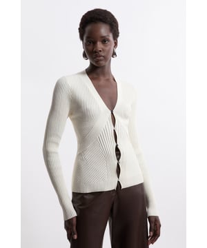 Feel cosy in our knit cardigan, with an silhouette that flaunts the figure, curved fastenings, and a ribbed texture. Style this piece with jeans or tailored trousers for an outfit that will take you from office days to wintery walks. Viscose Blend Curve Rib Detail Knit Cardigan High Quality Wool Fabric Deep V Neckline Comfortable, Figure Hugging Silhouette Directional Ribbed Texturing