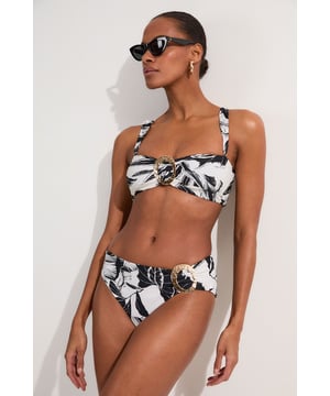 Make a statement this summer with these eye-catching high-waisted bikini bottoms from Karen Millen. The striking palm print design brings a touch of exotic flair to your beach ensemble, whilst the high-waisted cut elongates your legs and accentuates your curves. The gold-toned buckle detail adds a luxurious touch, perfect for those who love a bit of glamour by the pool. Pair with the matching top for a coordinated look, or mix and match with a solid-coloured bandeau for versatility. These bottoms are ideal for sunbathing, beach volleyball, or sipping cocktails at the resort bar. Whether you're jetting off to a tropical paradise or enjoying a staycation, these bikini bottoms will ensure you look and feel fabulous.  High-waisted design for a flattering silhouette Bold palm print pattern for a tropical vibe Decorative gold-toned buckle detail on the side Wide waistband for added comfort and support Moderate coverage at the back for confidence   Matching piece sold separately.
