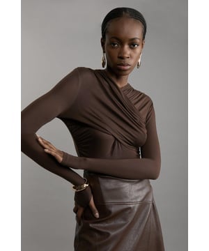 Update your wardrobe essentials with our long sleeve top, with a fitted silhouette, a high V neckline, and flattering, wrap detailing. Pair it with anything, from tailored trousers to jeans to mini skirts for looks that go from season to season. Premium Tencel Jersey Wrap Detail Long Sleeve Top High Quality Jersey Fabric Flattering Figure Hugging Fit High V Neckline Unique Wrap Style Design Long Sleeves