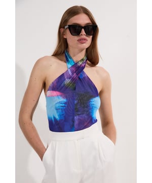 Step into summer in this feminine floral bodysuit. Featuring a delicate blossom print, this bodysuit features a flattering fitted silhouette that hugs the body, and a supportive halter neckline with cut out detail at the front. It also features a breathable open back design, ideal for summer weddings or sun-drenched garden soirees. Wear yours with a voluminous full skirt or sleek linen trousers. Floral Sheer Cross Neck Bodysuit  Breathable Mesh Fabric Practical Halter Neckline Feminine Floral Design Flattering Open Back Sultry Cut Out Detail Discover this seasons bodysuits or browse the full collection of women's tops now.
