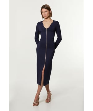 Elevate your cold weather wardrobe in our long sleeve dress, with a fitted silhouette, metallic zip detailing, and a unique V neckline. Style it with heeled boots or chunky loafers for an elevated day to night look. Zip Up Full Needle Knitted Dress High Quality Soft Knit Fabric Flattering Figure Hugging Silhouette Rounded V Neckline Zip Front Fastening Thigh High Leg Split
