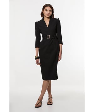This Karen Millen belted midi dress combines timeless elegance with contemporary styling. The structured silhouette creates a refined shape that flatters the figure, whilst the collared neckline adds a touch of tailored sophistication. The versatile design transitions from office to weekend, making it a wardrobe essential for those who appreciate understated luxury with practical appeal. The belted waist can be adjusted to customise your fit, creating a silhouette that works perfectly for family gatherings or casual social events.   Structured crepe fabric with subtle texture Elegant collared neckline with a flattering V-opening Three-quarter length sleeves Statement belt with rectangular buckle to define the waist Midi length design