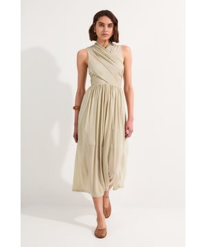 This Karen Millen wrap detail midi dress embodies refined elegance with its draped bodice and flowing silhouette. The thoughtfully designed crossover detail creates visual interest while the gathered waist cinches in to create a flattering feminine shape. Perfect for special occasions, style with metallic strappy heels and statement gold jewellery for a sophisticated wedding guest ensemble. For evening events, add a structured clutch and delicate drop earrings. The versatile midi length works equally well for daytime functions when paired with nude court shoes and a tailored blazer. The luxurious jersey fabric moves gracefully with every step, ensuring you remain comfortable throughout your event while maintaining an effortlessly polished appearance.  Elegant wrap detail across the bodice Sleeveless design with a flattering V-neckline Midi length Gathered waist detail