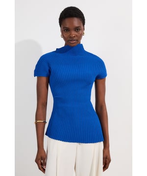 This Karen Millen Stitch Detail Knit Top combines contemporary design with timeless elegance. The striking asymmetric neckline offers a modern twist on daywear, whilst the ribbed texture adds sophisticated visual interest. Style with wide-leg trousers for a balanced silhouette that works for casual lunches and weekend outings. The versatile knit transitions effortlessly from day to evening, simply swap your flats for block heels and add a structured blazer for dinner with friends. This piece works wonderfully layered under a lightweight trench during transitional weather, making it a wardrobe staple that delivers style and comfort in equal measure.   Distinctive asymmetric neckline Figure-enhancing knitted fabric Short sleeves Sophisticated stitch detail Flattering fitted shape