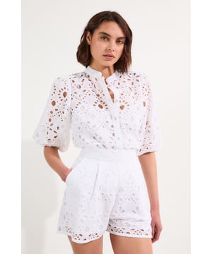 These exquisite broderie shorts from Karen Millen showcase exceptional craftsmanship with their intricate cut-out pattern. The high-waisted design creates a flattering shape that pairs with the woven shirt. For casual daywear, team with a simple tucked-in blouse and trainers for brunch with friends, or dress up with a fitted bodysuit and leather sandals for summer garden parties. The versatile length makes these shorts perfect for warm-weather holidays, simply add oversized sunglasses and a straw tote for effortless sophistication. The cotton fabric ensures breathability whilst the structured silhouette maintains shape throughout the day, making these shorts an essential addition to your warm-weather wardrobe for family gatherings and casual outings alike.  Intricate broderie anglaise detailing creates a floral pattern throughout High-waisted design with pleated front Scalloped hem with delicate cut-out pattern Side pockets