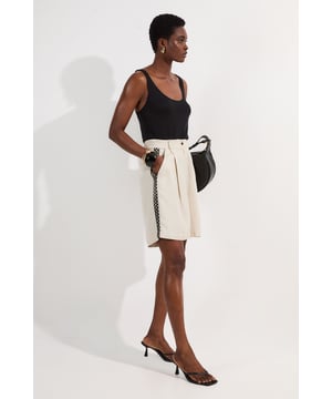 These Karen Millen shorts blend casual comfort with refined detailing, making them a versatile addition to your summer wardrobe. The contrasting lace trim inserts add visual interest to the clean, tailored silhouette, while the lightweight linen-mix fabric ensures breathability on warmer days. Style them as seen with a simple fitted vest top and strappy heels for an elevated daytime look, or pair them with a crisp white shirt and flat sandals for weekend brunches. Perfect for garden parties, coastal holidays, or casual family gatherings, these shorts offer effortless sophistication to your daywear collection.   Elegant woven shorts featuring delicate lace trim inserts High-waisted design with front pleats Secure button and zip fastening with belt loops Relaxed silhouette