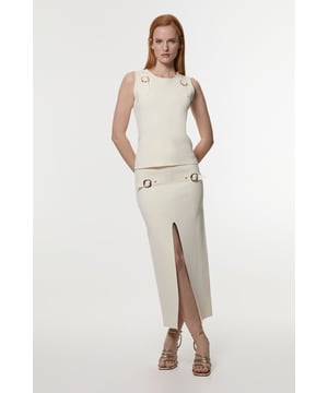 Sleek knitted design for a figure-hugging silhouette Distinctive buckle trim detailing for added interest Front slit for ease of movement and a touch of allure Midi length offering versatile styling options Stretchy fabric blend ensures comfort and a perfect fit  Embrace contemporary chic with this Karen Millen buckle trim knitted skirt. The form-fitting design accentuates your curves while the front slit adds a subtle hint of allure. Perfect for daytime events, this skirt can be effortlessly styled for various casual occasions. Pair it with a crisp white blouse and flat sandals for a sophisticated lunch date, or team it with a cosy jumper and trainers for a relaxed weekend look. The versatile midi length makes it ideal for family gatherings or casual outings. The stretchy fabric ensures all-day comfort, allowing you to move with ease whether you're running errands or enjoying a leisurely stroll in the park.