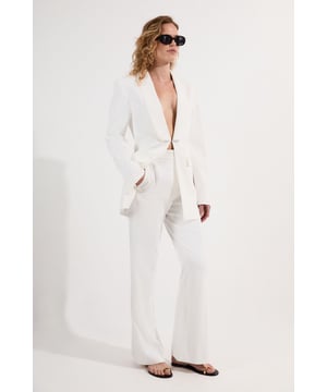 These Karen Millen tailored kick flare trousers present the perfect balance of contemporary style and classic workwear sophistication. The high-rise waistband creates a flattering shape that elongates the legs, while the subtle flare adds a modern twist to traditional office attire. Style them with a fitted button-front vest and coordinating blazer for a powerful suited look, or pair them with a crisp cotton shirt and court shoes for everyday elegance. The versatile design transitions seamlessly from important meetings to after-work gatherings, simply swap your structured tote for a clutch and add statement jewellery.  Tailored high-waisted design Kick flare shape Clean, minimalist styling Viscose-blend fabric