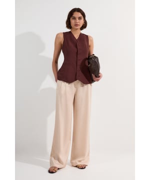 These sophisticated wide leg trousers from Karen Millen present a contemporary take on tailoring that commands attention. The high-waisted design creates a lengthening effect, while the generous cut through the leg offers both comfort and dramatic flair. Perfect for formal occasions, pair with the coordinating strapless bodice as shown for an elegant evening ensemble, or style with a crisp white blouse and pointed court shoes for a refined look suitable for summer weddings or race day events. For cooler evenings, layer with a tailored blazer to maintain the structured aesthetic. The versatile nature of these trousers allows them to transition seamlessly from daytime sophistication when worn with a silk camisole to evening glamour when accessorised with statement jewellery and a clutch bag.  Tailored wide leg trousers with elegant drape and flow High-waisted design with clean front pleating for a flattering silhouette Linen blend fabric offering breathability and structure Side pockets discreetly integrated into the design Full-length cut with generous width for dramatic movement