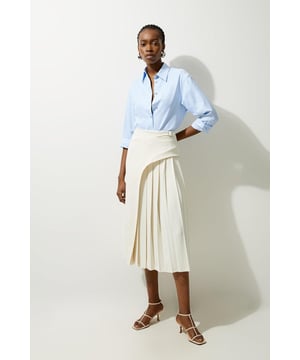 Feel elegant in our midi skirt, with a universally flattering silhouette, pleated detailing, and a high waistline, perfect for getting a little dressed up. Style this piece with strappy heels for an outfit that will turn heads from office days to upcoming occasions and events. Tailored Buckle Detail Pleated Midi Skirt Formal, Flowing Fit High Waistline Unique Pleated Panel Midi Length Metallic Buckle at WaistlineBrowse this seasons work skirts or discover the full range of workwear now.