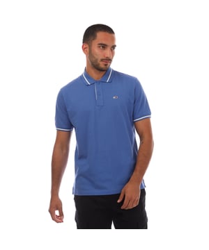 Mens Tommy Jeans Regular Fit Tipped Polo Shirt in blue.- Ribbed polo collar.- Two button placket.- Short sleeves with ribbed cuffs.- Contrast tipping at collar and cuffs- Embroidered Tommy Jeans flag patch at left chest.- Even vented hem.- Soft and comfortable cotton piqué fabric  made with at least 95% regenerative cotton.- Regular fit.- 100% Cotton.  Machine washable.- Ref: DM0DM20745C6E