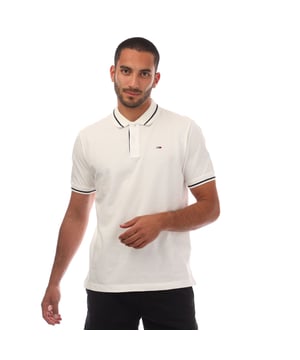 Mens Tommy Jeans Regular Fit Tipped Polo Shirt in white.- Ribbed polo collar.- Two button placket.- Short sleeves with ribbed cuffs.- Contrast tipping at collar and cuffs- Embroidered Tommy Jeans flag patch at left chest.- Even vented hem.- Soft and comfortable cotton piqué fabric  made with at least 95% regenerative cotton.- Regular fit.- 100% Cotton.  Machine washable.- Ref: DM0DM20745YBL