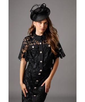 Exquisite all-over lace design with intricate floral pattern
        Elegant pearl button fastening down the front
        Collared neckline for a refined touch
        Short sleeves with delicate scalloped edges
        Fitted silhouette accentuating the feminine form
    
    Radiate sophistication in this stunning lace shirt, perfect for those special occasions that demand a touch of elegance. The intricate floral lace pattern creates a mesmerising texture, whilst the pearl button fastening adds a luxurious detail. Style this versatile piece for a wedding by pairing it with a sleek pencil skirt and strappy heels, or dress it down for a garden party with tailored trousers and elegant flats. The collared neckline and short sleeves offer a classic silhouette that can be accessorised to suit your personal style. Whether you're attending the races or a formal dinner, this shirt will ensure you stand out for all the right reasons. Its ability to transition from day to night makes it a wardrobe essential for the discerning woman who appreciates quality and timeless appeal.