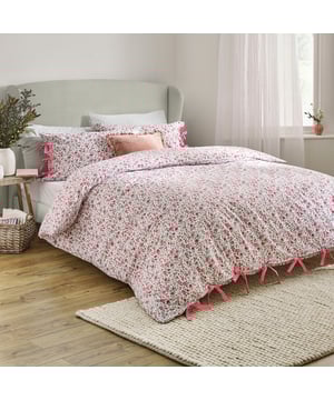 Elevate your bedroom with the Hannah Duvet Cover Set, designed to bring a touch of natural elegance to your space. Crafted from 100% tumbled cotton with a soft 144 thread count, this set promises a breathable, luxurious night's sleep. The timeless floral pattern, printed on both sides, offers effortless versatility while perfectly blending sophistication with countryside-inspired charm. Thoughtful bow-closure details add a delicate, handcrafted aesthetic, while ensuring a secure fit. Whether styled in a sleek modern setting or a relaxed country retreat, this duvet cover invites refined comfort and nature-inspired beauty into your home.