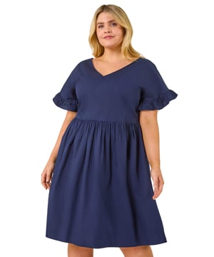 Curve Cotton V-Neck Frill Dress from Roman. Step into the warmer months with style in this lovely Curve frill sleeve dress. Crafted from a lightweight woven fabric, this dress features a trendy v-neckline and short sleeves with delicate frill cuffs for a feminine touch. Falling above the knee, this dress is perfect for sunny days and casual outings. Pair it with sandals and a denim jacket for an easy Summer look!