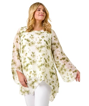 Curve Floral Print Overlay Top from Roman. Get ready to bloom this Spring Summer in our Curve floral print overlay top! With a classic round neckline and elegant long sleeves, this top is adorned with beautiful floral prints flow down the soft woven fabric. The chiffon overlay adds a touch of sophistication to this piece, falling at an asymmetric hem. Perfect for pairing with linen trousers and sandals!