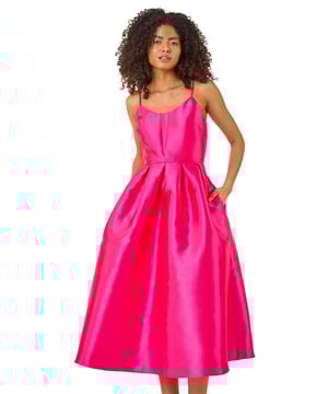Dusk Twill Cami Pleated Midi Dress from Roman. Unleash your inner beauty in this luxurious satin cami dress, perfect for Spring and Summer. The twill fabric effortlessly falls into a flattering midi length with a pleated skirt detail, while the delicate cami straps add a touch of elegance. Complete the look with a bolero and heels for a sophisticated outfit destined to turn heads at any event!