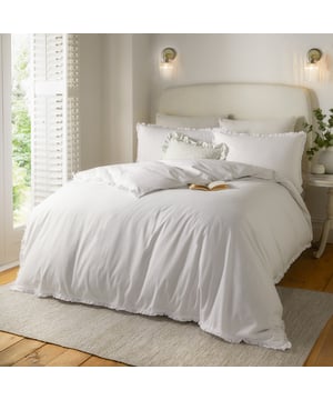 Transform your bedroom into a calm, soothing retreat with the Tilly Ruffle Duvet Cover Set. Crafted from luxuriously soft, breathable tumbled cotton with a 144 thread count, it ensures comfort throughout the seasons while inviting restful sleep. The subtle ruffle trim on the duvet and pillowcases adds a touch of timeless charm, blending effortlessly with both classic and modern interiors. Designed for those who cherish understated elegance, this minimalistic set brings a sense of effortless sophistication to your space, creating a serene sanctuary where style and comfort meet seamlessly.