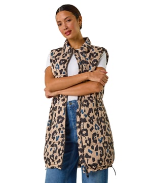Animal Print Hooded Gilet from Roman. Stay stylish and on-trend this Spring Summer with this animal print hooded gilet in a longline silhouette. The eye-catching animal print adds a wild twist to this quilted piece, featuring a zip and practical zip pockets at the front. The gilet boasts a cosy funnel neck and a drawcord hood. Layer it over your favourite shirt and jeggings for a fashionable look that's versatile and perfect for the season!