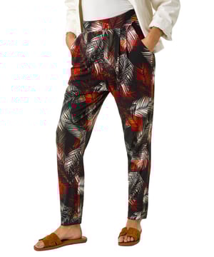 Leaf Print Harem Trouser from Roman. Embrace the tropical vibes with these leaf print harem trousers. Designed with an all over print, these trousers feature two front pockets and offer a comfortable, full-length fit. Pair with a simple cami top and sandals for a laid-back and stylish Spring/Summer look that's perfect for any casual outing!