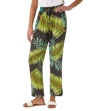Shimmer Palm Print Harem Trouser from Roman. Elevate your wardrobe with these stylish palm shimmer harem trousers, designed for both comfort and elegance. Featuring a flattering elasticated waist with an adjustable drawcord, they offer a perfect fit while the lightweight, flowy fabric adds effortless movement. Ideal for warm-weather days and holiday escapes, pair them with a cami top and sandals for an effortlessly chic look.