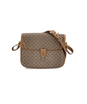 VINTAGE, RRP AS NEW
A true relic of understated luxury, this Gucci Vintage Flap Shoulder Bag in classic beige monogram canvas is a love letter to the house's heritage. Crafted in beige GG monogram canvas and finished with beige genuine leather trim, it's a nod to Gucci's heritage in all the right ways.  The front flap is accented with an elegant gold-tone detail and secures with a discreet button closure. A convenient open pocket under the flap adds easy-access storage, while the beige interior reveals a side zip pocket for your smaller essentials. Inside, you'll find the 'GUCCI Italy' crest, with the original serial number stamped on the reverse - a quiet mark vintage collectors appreciate.  This is the kind of piece that lives many lives: slung over the shoulder of a chic traveler in the '80s, tucked under the arm of a café-goer in Milan, and now ready for its next chapter. For lovers of vintage Gucci, this shoulder bag is more than an accessory - it's a tangible piece of the maison's storied past, with every stitch and crease echoing the charm of another era.  Condition Rating: B - VERY GOOD CONDITIONCondition Details: Some scratches and darkness on leather trim. Some scratches on the internal lining. Please check the photos carefully and ask if you need to know more details or if you have any doubts.Measurements (cm):Depth: 6.4Height: 17.8Length: 21.6Other Details: Dustbag? NoKeys? NoBox? No Measurments:  width: 64 mm length: 216 mm height: 178 mm
