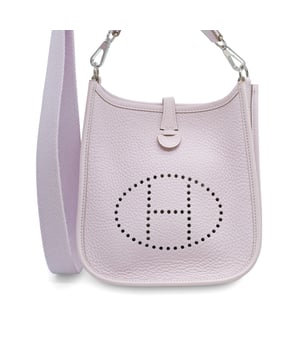 VINTAGE, RRP AS NEW
The Taurillon Clemence Evelyne TPM bag in Mauve Pale is an elegant small messenger bag made of Taurillon Clemence calfskin in pale pink. It features a perforated Hermes H oval on the front and a canvas shoulder strap with palladium hardware. The top opens with a criss-cross strap to access a suede interior.
Inclusions: dust bag Measurments:  width: 406 mm height: 457 mm