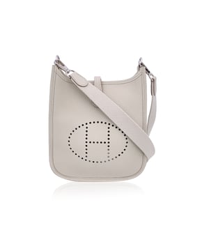 VINTAGE, RRP AS NEW
This beautiful Bag will come with a Certificate of ity provided by Entrupy. The certificate will be provided at no further cost.  Introducing the timeless elegance of the Hermes 'Mini Evelyne 16 Amazone' shoulder bag, crafted in sumptuous Togo leather. Originally designed by Evelyne Bertrand, Head of the Hermès Riding Department, in 1978, this iconic piece reflects the heritage and sophistication synonymous with the House of Hermes. The distinct perforated 'H' on the front serves as an unmistakable signature, while the fold-over strap closure and sleek, minimal design exude effortless luxury.  This mini version, with its versatile removable and adjustable shoulder strap, offers both style and practicality, perfect for daily wear or as a standout accessory for special occasions. The interior is lined in suede, maintaining the refined craftsmanship that Hermes is known for.  Stamped with 'Hermes Paris - Made in France' on leather and on the shoulder strap, the bag also bears the year of production 'W' (2024), discreetly embossed on the reverse of the leather closure strap.  Whether you're a long-time collector or a newcomer to Hermes, the 'Evelyne 16 Amazone' is a true testament to the brand's legacy of creating pieces that combine both function and fashion in a way only Hermes can. Condition Rating: A - EXCELLENTCondition Details: Gently used. Hermes dustbag included. Please check the photos carefully and ask if you need to know m ore details or if you have any doubts.Measurements (cm):Depth: 5.1Height: 17.8Length: 19.1Other Details: Dustbag? YesKeys? NoBox? No Measurments:  width: 51 mm length: 191 mm height: 178 mm