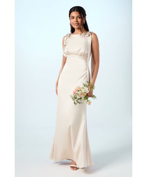 Sleeveless high neck design with elegant shoulder tie detail for a sophisticated silhouette
        Luxurious satin fabric that catches the light beautifully as you move
        Petite-specific proportions ensuring the perfect fit for shorter frames
        Floor-sweeping maxi length creating a graceful, elongating effect
        Subtle back detailing that adds interest when viewed from all angles
    
    This Coast Honoured bridesmaid dress combines timeless elegance with contemporary design elements. The high neckline and shoulder tie detail create a refined look that photographs beautifully during wedding celebrations. The fluid satin fabric drapes gracefully around the figure, whilst the maxi length ensures a formal, sophisticated presence within the bridal party. Style with delicate jewellery and a sleek updo to complement the clean lines of the dress. For footwear, metallic strappy heels work wonderfully, allowing you to dance comfortably throughout the reception. This bridesmaid dress has been specifically proportioned for petite frames, ensuring you won't need additional alterations before the big day. The understated elegance of this gown makes it the perfect supporting piece for the bride's special moment, whilst still allowing you to feel confident and beautiful.