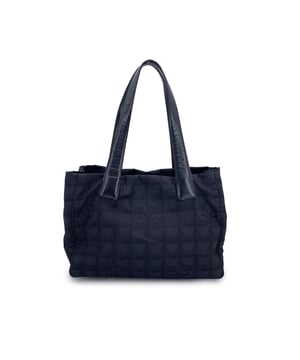 VINTAGE, RRP AS NEW
Chanel Travel Line Tote (2003-2004) - Understated Elegance in Motion  Timeless, functional, and distinctly Chanel - this black jacquard nylon tote from the house's Travel Line collection is a minimalist masterpiece from the 2003-2004 era, designed with the modern voyager in mind.  Crafted from sleek black jacquard nylon, the bag features the iconic Chanel motif subtly woven into the fabric - a quiet nod to the maison's storied heritage. The silhouette is elevated by a black leather shoulder straps/handles, offering both comfort and sophistication for life on the move.  Inside, the nylon lining holds two side zip pockets, perfect for keeping essentials within reach while maintaining the tote's clean lines. True to Chanel's legacy of craftsmanship, the interior bears the 'Chanel - Made in Italy' tag and a discreet ity hologram, grounding this vintage gem in ity and history.  Effortlessly chic and endlessly versatile, this Chanel Travel Line tote is a sophisticated companion - ideal for everyday elegance, city strolls, or quiet getaways. A rare find for collectors and lovers of early-2000s Chanel. Condition Rating: B - VERY GOOD CONDITIONCondition Details: Some wear of use on bottom corners. Some normal wear of use on leather handles. Please, look carefully at the photos and ask if you have any doubts.Measurements (cm):Depth: 11.4Height: 20.3Length: 27.9Other Details: Dustbag? NoKeys? NoBox? No Measurments:  width: 114 mm length: 279 mm height: 203 mm