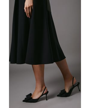 Elegant satin court shoes with a striking bow detail
        Slingback design for a secure and comfortable fit
        Medium stiletto heel measuring between 5 and 6.5cm
        Pointed toe silhouette for a sophisticated look
        Versatile style suitable for various formal occasions
    
    Step into elegance with these exquisite Lola satin court shoes from Coast. The eye-catching bow detail adorning the pointed toe adds a touch of feminine charm, while the slingback design ensures a secure fit as you glide across the dance floor. With a medium stiletto heel that strikes the perfect balance between comfort and style, these shoes are ideal for weddings, race days, or any sophisticated soire. Pair them with a flowing midi dress for a timeless ensemble, or contrast their delicate appearance with a sharply tailored suit for a modern twist. The versatility of these shoes makes them a wardrobe staple for the discerning woman who appreciates quality and style in equal measure.