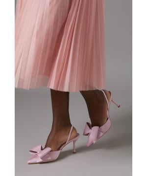 Elegant satin court shoes with a striking bow detail
        Slingback design for a secure and comfortable fit
        Medium stiletto heel measuring between 5 and 6.5cm
        Pointed toe silhouette for a sophisticated look
        Versatile style suitable for various formal occasions
    
    Step into elegance with these exquisite Lola satin court shoes from Coast. The eye-catching bow detail adorning the pointed toe adds a touch of feminine charm, while the slingback design ensures a secure fit as you glide across the dance floor. With a medium stiletto heel that strikes the perfect balance between comfort and style, these shoes are ideal for weddings, race days, or any sophisticated soire. Pair them with a flowing midi dress for a timeless ensemble, or contrast their delicate appearance with a sharply tailored suit for a modern twist. The versatility of these shoes makes them a wardrobe staple for the discerning woman who appreciates quality and style in equal measure.