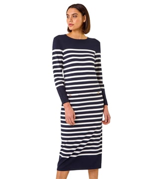 Stripe Print Knit Midi Dress from Roman. Unleash your stylish side with this chic stripe knit midi dress perfect for Autumn/Winter. Crafted from a soft knitted fabric, this dress features a classic round neckline and elegant long sleeves. The standout detail of applied patch pockets with gold buttons adds a touch of sophistication. Pair with tights and ankle boots for a trendy look that will take you from day to night effortlessly!