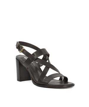Designed with clean lines, an adjustable ankle strap, cross over front straps, and branded hardware, this block sandal offers a sleek balance of comfort and sophistication.