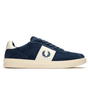 The Fred Perry B4 Suede trainers blend classic court styling with luxurious materials. Crafted with a regular suede quarter and tongue, these blue men's trainers feature distinctive hairy suede on the facing, vamp, and heel counter. The nubuck overlay panel and heel tab add subtle texture variations, while environmentally conscious details like recycled spun polyester laces demonstrate Fred Perry's commitment to sustainability. With their timeless silhouette and durable white rubber sole, these versatile trainers effortlessly complement both casual and smart-casual outfits.