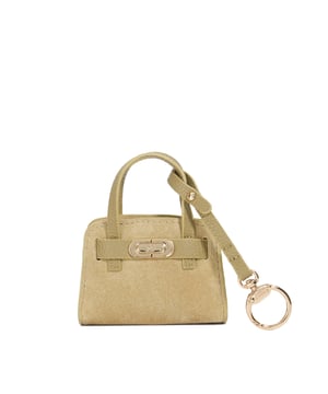 Our dinky mini Define bag charm has been meticulously crafted from suede and finished with an embossed logo clasp and  gold hardware bow clasp, for attaching onto a bag.