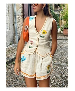 Two
  piece set
  Buttoned vest with V
  neck
  100% polyester
  Machine wash cold tumble dry low
  Imported
  Available in sizes S M L XL
  Top Length: S
  18.9 inches M
  19.3 inches L
  19.7 inches XL
  20.1 inches
  Bust: S
  33.9 inches M
  35.4 inches L
  37.8 inches XL
  40.2 inches
  Bottom Length: S
  12.6 inches M
  13 inches L
  13.4 inches XL
  13.8 inches
  Waist: S
  26.8 inches M
  28.3 inches L
  30.7 inches XL
  33.1 inches
Material: Linen Blend