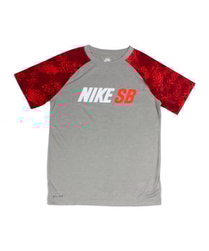 Nike SB Kids Dri-FIT T-Shirt in dark grey heather with bold red branding. Made with moisture-wicking Dri-FIT fabric to keep kids cool and comfortable during play or skate sessions. Classic crew neck and short sleeves for easy everyday wear.