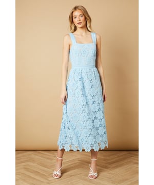 Elegant square neckline with delicate floral lace detailing throughout
        Wide shoulder straps with scalloped lace trim for added feminine charm
        Fitted bodice with defined waistband creating a flattering silhouette
        Midi-length design with intricate all-over floral lace pattern
        A-line skirt that gracefully falls to mid-calf length
    
    This enchanting Oasis midi dress showcases exquisite floral lace detailing that makes it perfect for special occasions. The square neckline frames the dcolletage beautifully, while the defined waistband accentuates your natural curves. Style with strappy heeled sandals and statement earrings, as shown on our model, for weddings or formal garden parties. For race day events, pair with a fascinator and clutch bag for a sophisticated ensemble. The versatile midi length works wonderfully for both daytime celebrations and evening soires. This dress can be styled differently with a tailored blazer and court shoes for graduation ceremonies or paired with delicate jewellery for elegant dinner dates. Machine washable for convenient care, this dress combines timeless femininity with practical wearability.