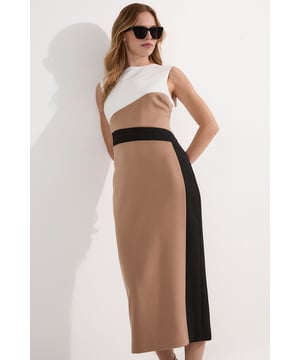 Make a statement in this Karen Millen Compact Stretch Colourblock Tailored Pencil Dress, designed to showcase modern sophistication with its bold contrasting panels. The tailored silhouette gracefully contours the body while the stretch fabric ensures comfort throughout the day. Style this versatile piece with pointed flats and a structured tote for daytime meetings, or dress it down with white trainers and a denim jacket for weekend brunches. This dress transitions effortlessly from office to evening drinks with a simple change of accessories.  Colourblock design with bold contrast panels Tailored pencil silhouette with a midi length Round neckline Compact stretch fabric Back vent detail