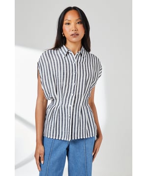 Crafted from a breathable cotton-linen blend for exceptional comfort in warm weather
        Distinctive pleat detail creates a flattering cinched waist silhouette
        Relaxed cap sleeves offer effortless movement and contemporary styling
        Classic button-through design with smart collar for versatile styling options
        Timeless stripe pattern adds visual interest to this wardrobe essential
    
    This Principles striped shirt combines casual comfort with refined detailing for everyday sophistication. The pleated waist creates a feminine silhouette that flatters your figure without sacrificing comfort. Style with wide-leg denim trousers as shown for a balanced daytime look perfect for weekend brunches or casual gatherings. For a more polished appearance, tuck the front into tailored linen trousers and add leather sandals. The cotton-linen fabric ensures breathability during warmer months whilst maintaining structure throughout the day. This versatile piece transitions effortlessly from office to outdoor caf, making it an indispensable addition to your casual wardrobe. Accessorise with simple gold-toned jewellery to complement the classic nautical-inspired pattern for family gatherings or informal social events.