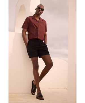 Resort-style shirt with classic camp collar design for a relaxed aesthetic
        Short sleeves with clean-finished edges for a neat, contemporary look
        Textured fabric blend featuring linen for breathability and comfort
        Straight hem with side splits allowing for versatile styling options
        Button-through front with tonal buttons for a sophisticated finish
    
    This Burton resort shirt combines casual comfort with effortless style, perfect for the modern man who appreciates classic design. The textured fabric offers a natural drape that looks equally impressive worn open over a plain t-shirt or buttoned up for a smarter appearance. Style with tailored shorts and leather sandals for warm-weather socialising, or pair with chino trousers and trainers for casual Friday at the office. The versatile design transitions seamlessly from daytime barbecues to evening drinks at your local, making it a wardrobe essential for the British summer. For cooler evenings, layer under a lightweight bomber jacket or unstructured blazer to maintain that relaxed yet put-together look that Burton is known for. Machine washable at 30 degrees, this shirt offers practicality alongside its undeniable style credentials.