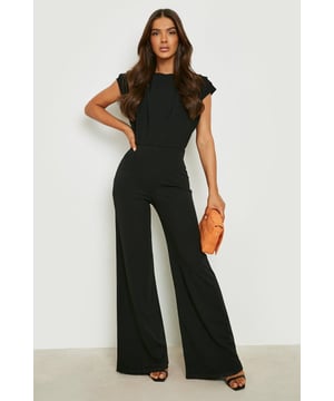 Elegant ruched detail on one shoulder
        Flattering wide leg silhouette
        Sleek crew neckline
        Versatile one-piece design
        Stretchy fabric for comfortable fit
    
    Make a statement in this striking wide leg jumpsuit, perfect for your next night out. The ruched detail on one shoulder adds a touch of sophistication, while the sleek crew neckline keeps the look modern and chic. Pair with strappy heels and statement earrings for a head-turning ensemble that's sure to impress. The wide leg cut elongates your silhouette, making it ideal for dancing the night away or sipping cocktails at a trendy bar. For a more casual look, throw on a leather jacket and trainers. The stretchy fabric ensures comfort throughout your evening, allowing you to move with ease. Whether you're meeting friends for drinks or hitting the club, this jumpsuit is your go-to for effortless style that commands attention.