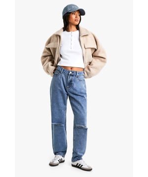 High-waisted design for a flattering silhouette
        Distressed detailing on knees for an edgy look
        Relaxed mom-jean fit through hips and thighs
        Classic five-pocket styling
        Ankle-length cut perfect for showcasing footwear
    
    Embrace the revival of 90s fashion with these trendy petite mom jeans. The high-waisted cut accentuates your curves while the relaxed fit through the hips and thighs offers supreme comfort for all-day wear. The distressed knee detailing adds a touch of rebellious charm, making these jeans perfect for creating that coveted lived-in look. Style them with a cropped white top and oversized jacket for a casual day out, or dress them up with a bodysuit and heeled boots for a night on the town. These versatile jeans transition seamlessly from brunch with friends to an impromptu shopping spree. Pair with trainers for a laid-back vibe or ankle boots to add a touch of sophistication. The ankle-length cut is ideal for showing off your favourite footwear, making these jeans a true wardrobe staple for the fashion-forward Boohoo girl.