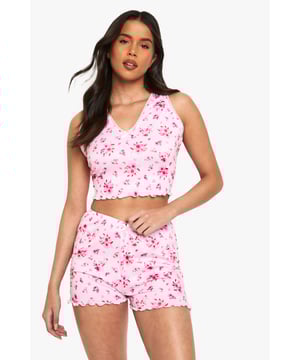 Charming floral print pyjama set
        Delicate lace trim detailing
        Sleeveless crop top with V-neckline
        Matching shorts with scalloped hem
        Comfortable and stylish two-piece design
    
    Drift off to dreamland in style with this enchanting floral pyjama set from Boohoo. The sleeveless crop top features a flattering V-neckline adorned with delicate lace trim, while the matching shorts boast a charming scalloped hem. Perfect for warm summer nights or cosy evenings in, this set combines comfort with a touch of feminine flair. Layer with a soft dressing gown for those chilly mornings, or pair the top with your favourite lounge trousers for a mix-and-match look. Whether you're having a pamper night in or a girly sleepover, this versatile set will ensure you look and feel fabulous even as you slumber.
