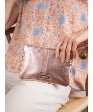 Compact, stylish, and effortlessly functional, the Tarnly purse pouch is designed for everyday ease. Crafted from supple leather, it features a refined front logo emboss and whipstitch detailing along the sides for a touch of artisanal charm. The zip-top closure is finished with a sleek leather wrist strap, making it perfect for carrying solo or slipping into a larger bag. Inside, a satin-lined interior offers thoughtful organisation with a slip pocket and three card slots, while built-in RFID protection keeps your essentials secure.&nbsp;