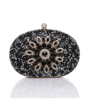 Glamorous oval clutch bag featuring dazzling diamante embellishments. A perfect statement piece for evening events and special occasions.
Short Handle and long Chain Strap Included. Clean With Soft Brush Gently.
Outer - Polyester and glass beads Lining - Polyester.
H 14cm D4cm W 20cm. SKU: HB345702.