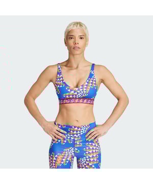 A kaleidoscopic print makes this adidas sports bra a colourful addition to your workout wardrobe. Made for medium-impact exercise like volleyball, gym sessions and cycling, it has mesh panels in high-heat zones to keep air circulating. Moisture-managing AEROREADY fabric keeps you dry so you can focus on your training. This product is made with at least 70% recycled materials. By reusing materials that have already been created, adidas help to reduce waste and our reliance on finite resources and reduce the footprint of the products adidas make.  - Tight fit - Scoop neck with double back straps - 85% polyester (recycled), 15% elastane - AEROREADY - Removable pads - Elastic bottom band - Pullover style - Mesh panels in high-sweat zones  Shipped by adidas